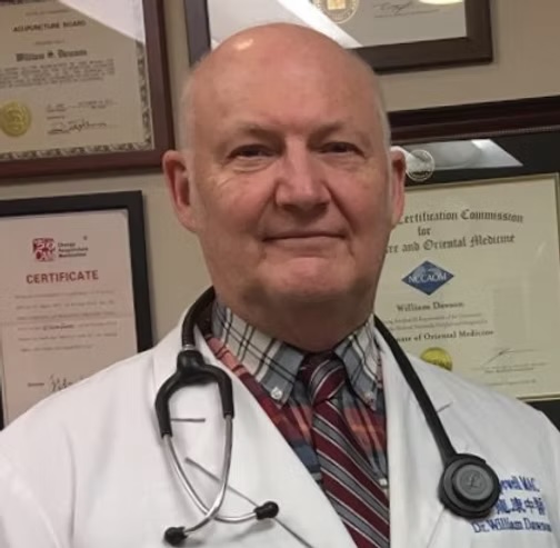 Dr. William Dawson in white clinical coat with stethoscope, board certifications framed behind him